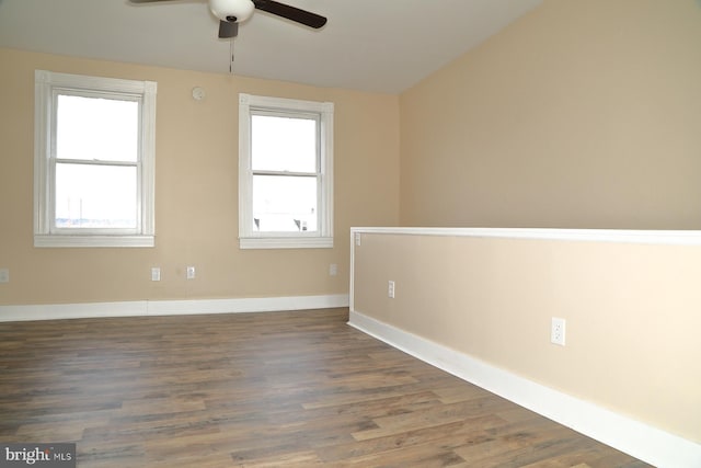 spare room with ceiling fan, dark hardwood / wood-style flooring, and vaulted ceiling