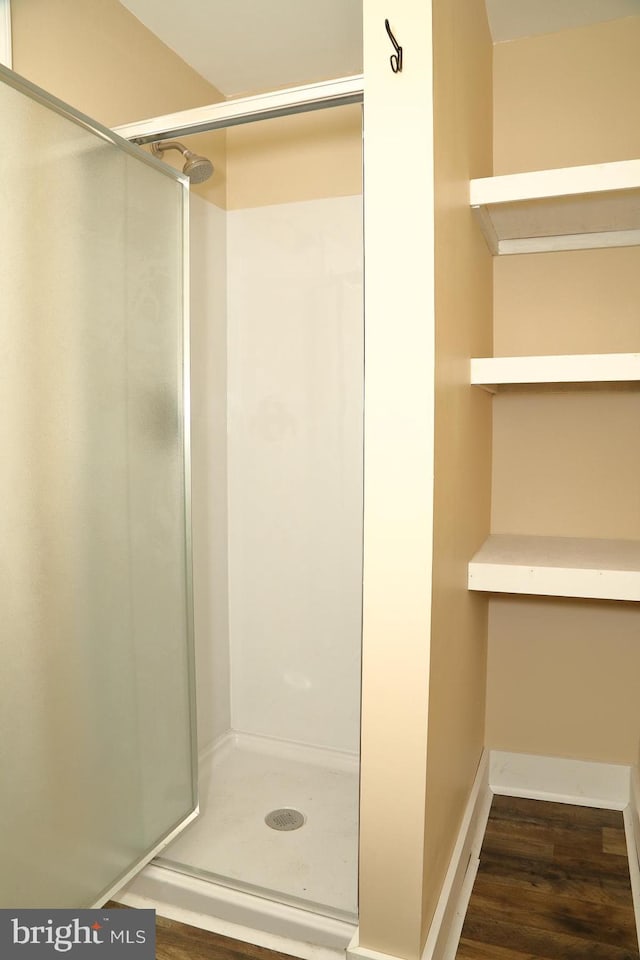 bathroom featuring hardwood / wood-style floors and walk in shower