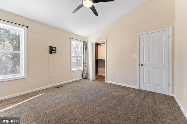 unfurnished bedroom with lofted ceiling, ceiling fan, and carpet flooring