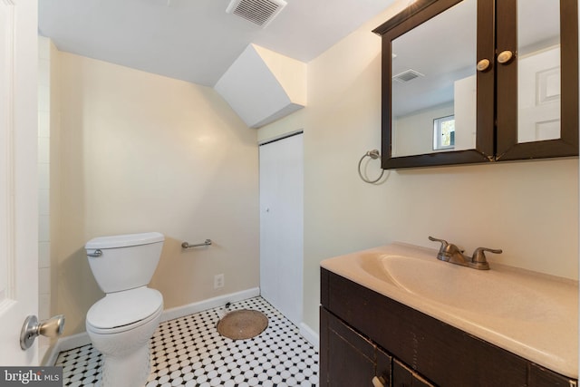 bathroom with toilet, tile patterned flooring, and vanity