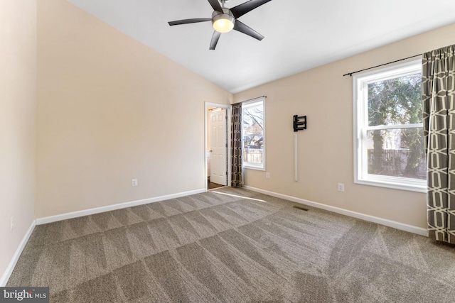 carpeted spare room featuring lofted ceiling and ceiling fan