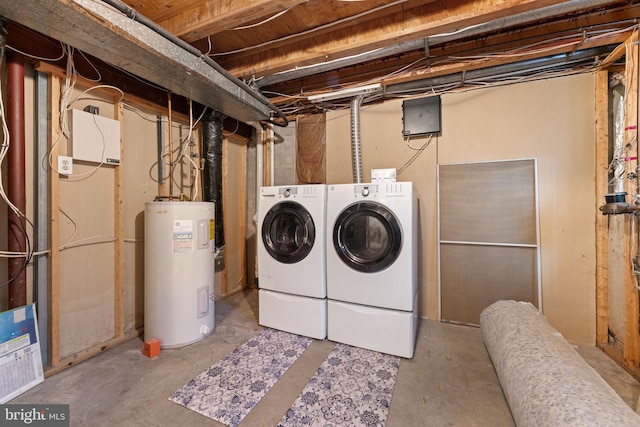 clothes washing area featuring washer and clothes dryer and water heater