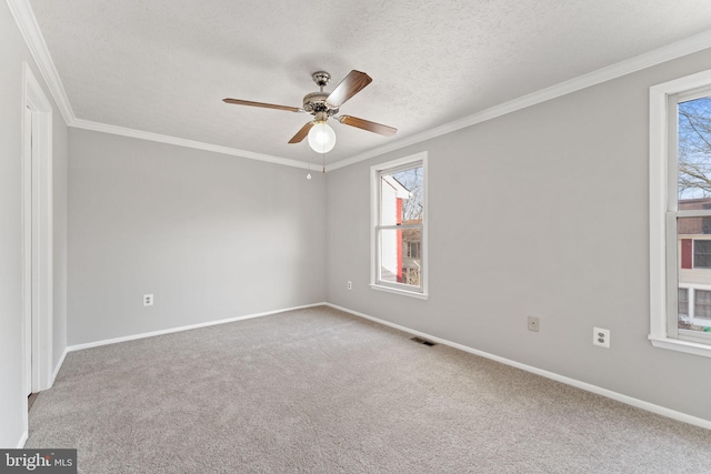 unfurnished room featuring carpet floors, a textured ceiling, and ornamental molding