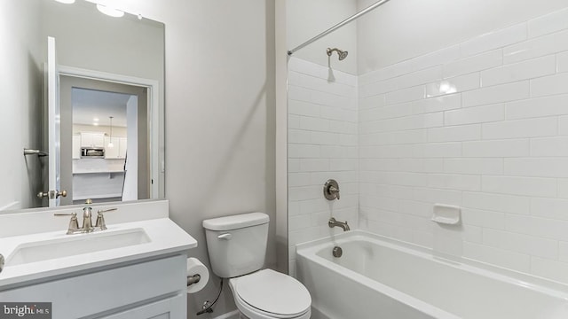 full bathroom featuring vanity, toilet, and tiled shower / bath combo