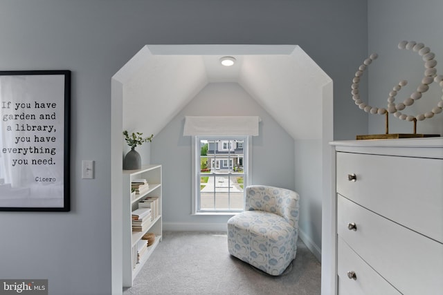 living area featuring carpet floors and vaulted ceiling