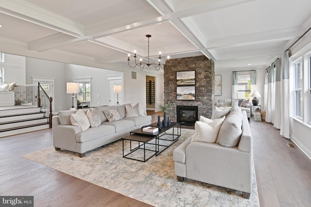 living room featuring a fireplace, light hardwood / wood-style flooring, and a healthy amount of sunlight