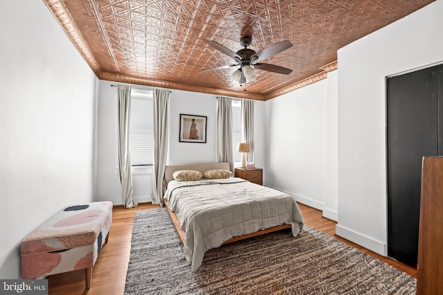 bedroom with ceiling fan and light hardwood / wood-style flooring