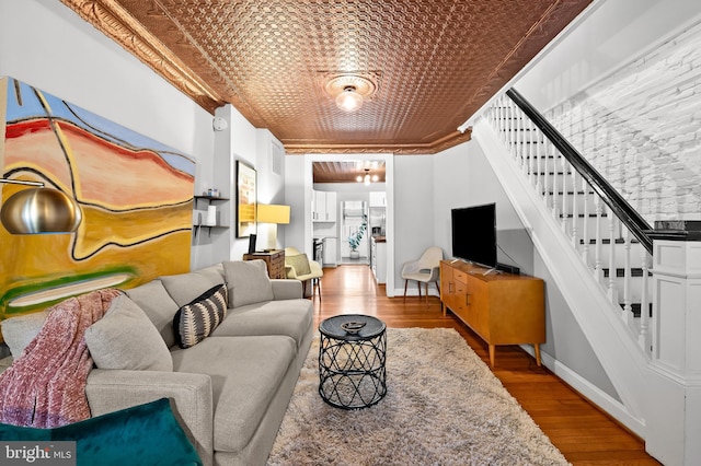 living room featuring light hardwood / wood-style flooring and ornamental molding