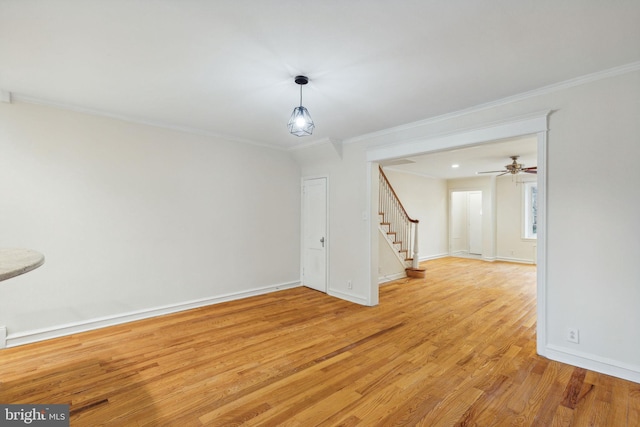 empty room featuring ceiling fan, light hardwood / wood-style flooring, and ornamental molding