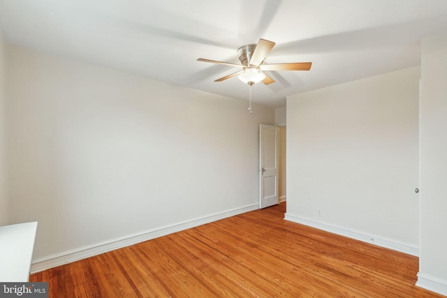 empty room featuring ceiling fan and light hardwood / wood-style flooring