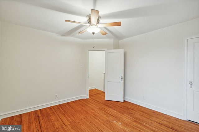 empty room with ceiling fan and light hardwood / wood-style floors