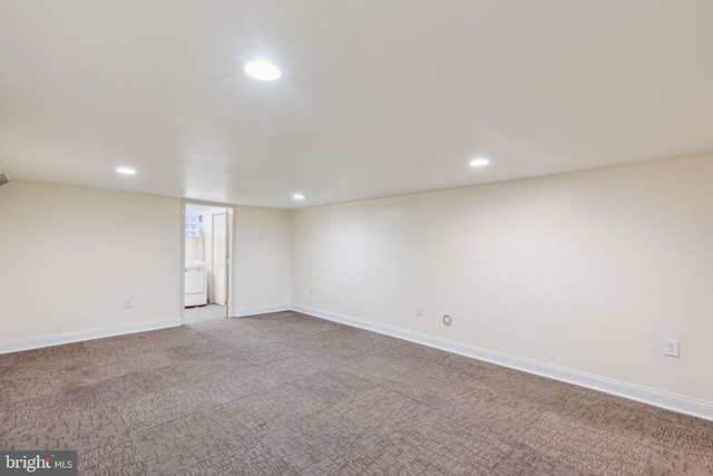 spare room featuring carpet and washer / clothes dryer