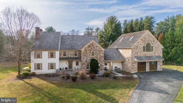 view of front of property with a garage and a front yard