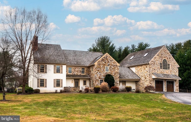 view of front facade with a garage and a front lawn