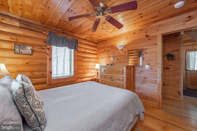 bedroom with wood-type flooring, multiple windows, wooden ceiling, and ceiling fan