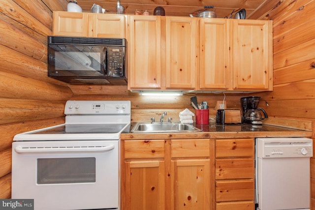 kitchen featuring light brown cabinetry, white appliances, rustic walls, and sink