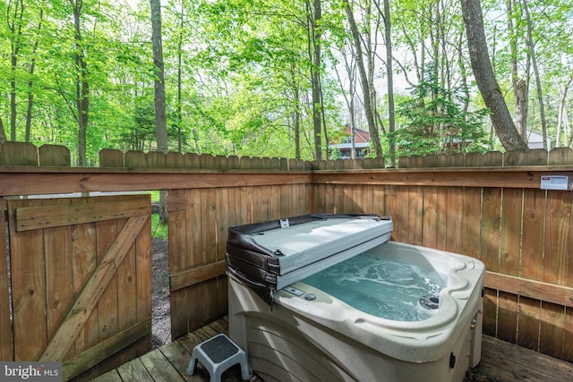 wooden terrace with a hot tub