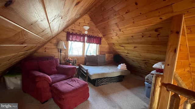 carpeted bedroom with wood walls, wooden ceiling, and vaulted ceiling