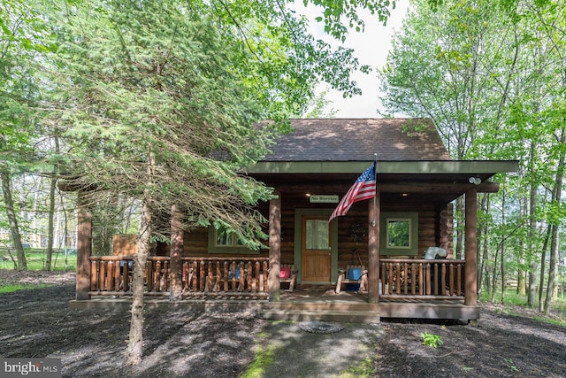 log cabin featuring a porch