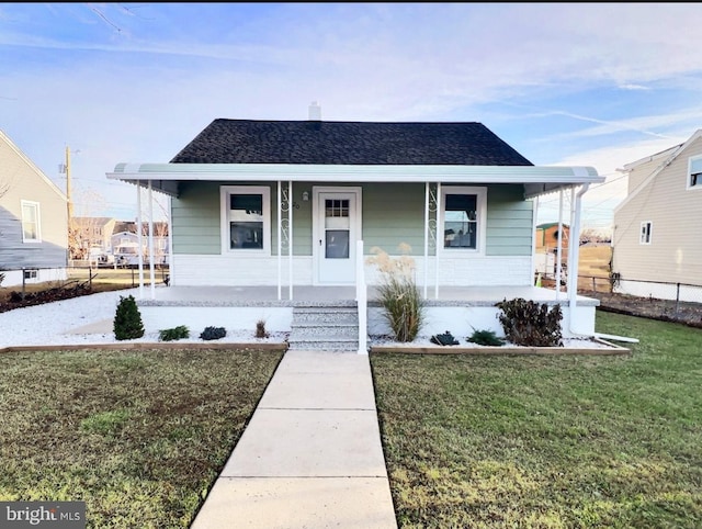 bungalow-style home with a front lawn