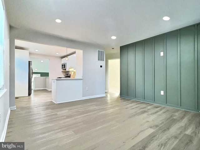 unfurnished living room featuring light hardwood / wood-style floors