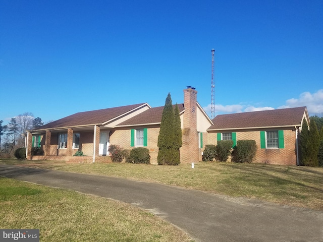 ranch-style house with a front lawn