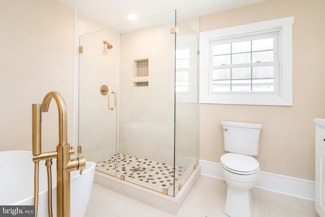 bathroom with tile patterned floors, a shower with door, vanity, and toilet