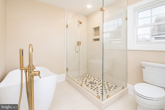 bathroom with tile patterned flooring, toilet, and independent shower and bath