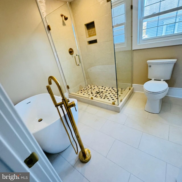 bathroom featuring toilet, tile patterned floors, and independent shower and bath