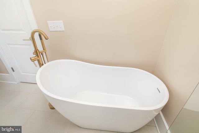 bathroom with tile patterned floors and a bathtub