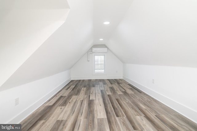 bonus room featuring wood-type flooring and vaulted ceiling