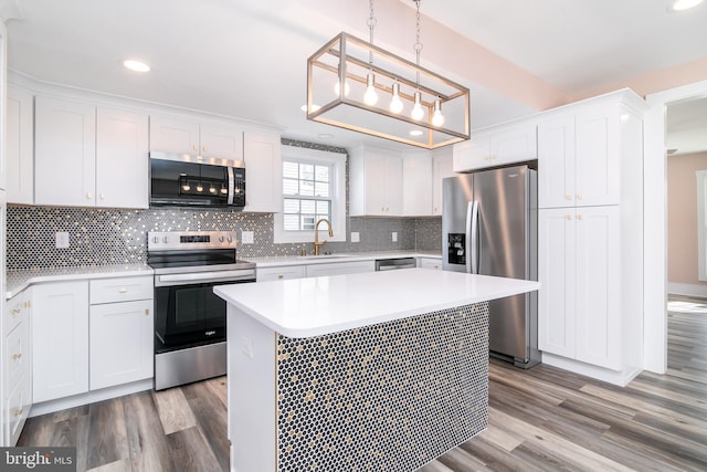 kitchen featuring white cabinetry, a center island, and appliances with stainless steel finishes