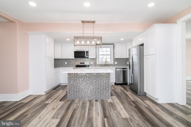 kitchen featuring pendant lighting, dark hardwood / wood-style flooring, and stainless steel appliances