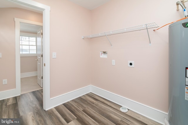 laundry area with electric water heater, hookup for a washing machine, hookup for an electric dryer, and hardwood / wood-style flooring