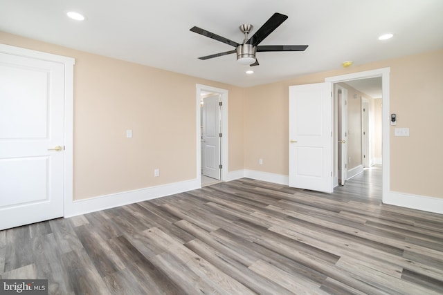 unfurnished bedroom with ceiling fan, wood-type flooring, and a closet