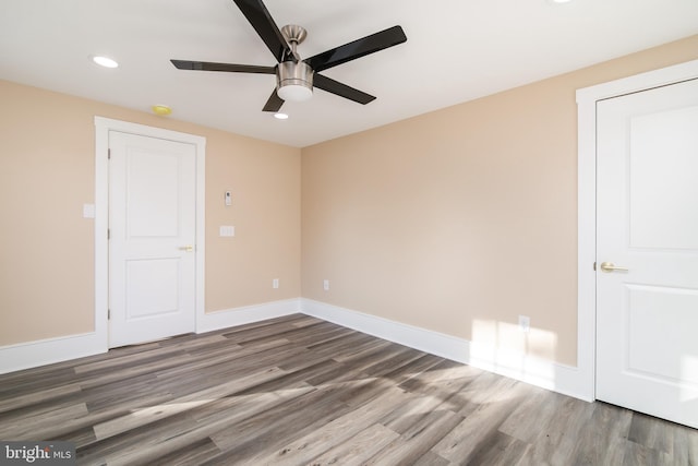 spare room featuring ceiling fan and dark wood-type flooring