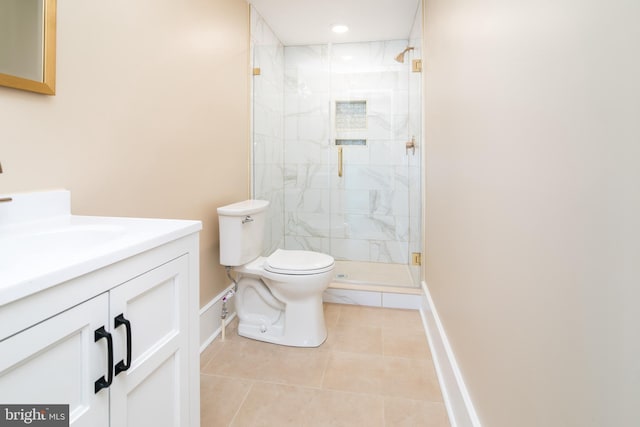 bathroom with tile patterned floors, vanity, toilet, and a shower with door