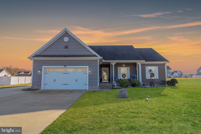 view of front of home with a lawn and a garage