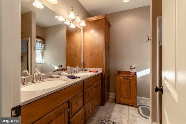 bathroom featuring tile patterned flooring and vanity