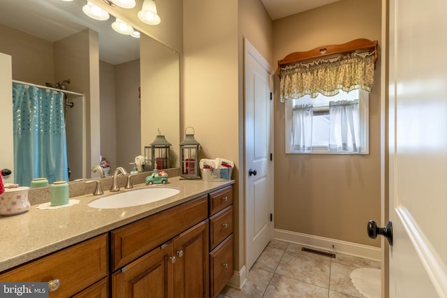 bathroom with tile patterned floors, vanity, and walk in shower