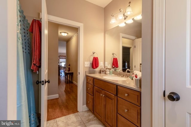 bathroom with hardwood / wood-style floors, vanity, and curtained shower