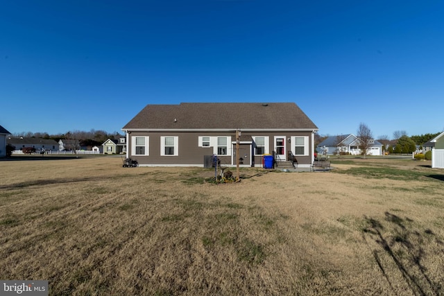 back of house with a lawn