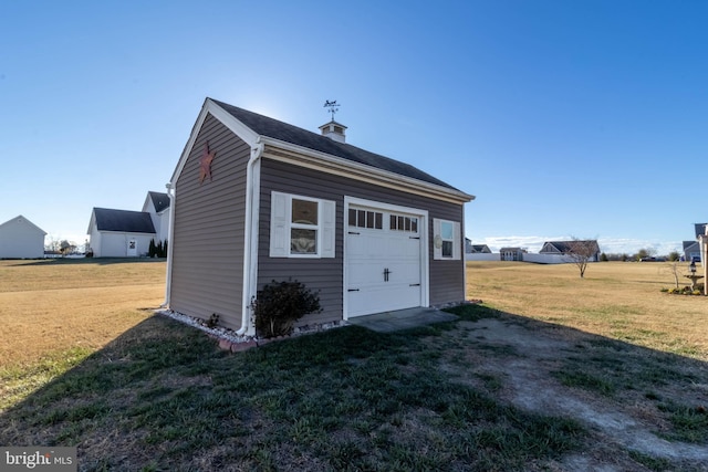 view of outbuilding with a lawn and a garage