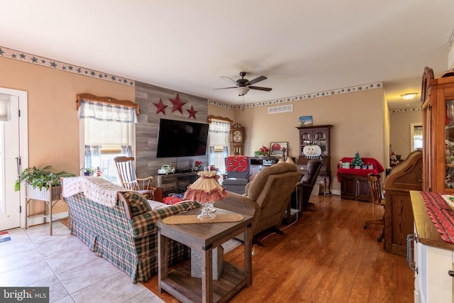 living room featuring ceiling fan and light wood-type flooring