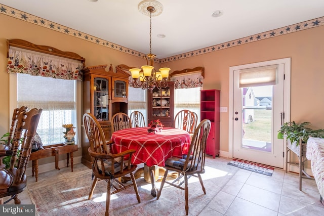 tiled dining area with a chandelier