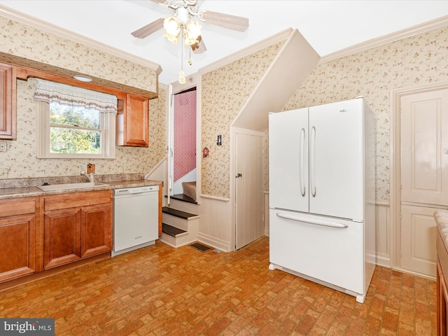 kitchen featuring a wainscoted wall, white appliances, crown molding, and wallpapered walls