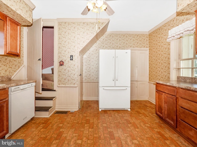 kitchen featuring white appliances, wallpapered walls, wainscoting, ornamental molding, and brick floor