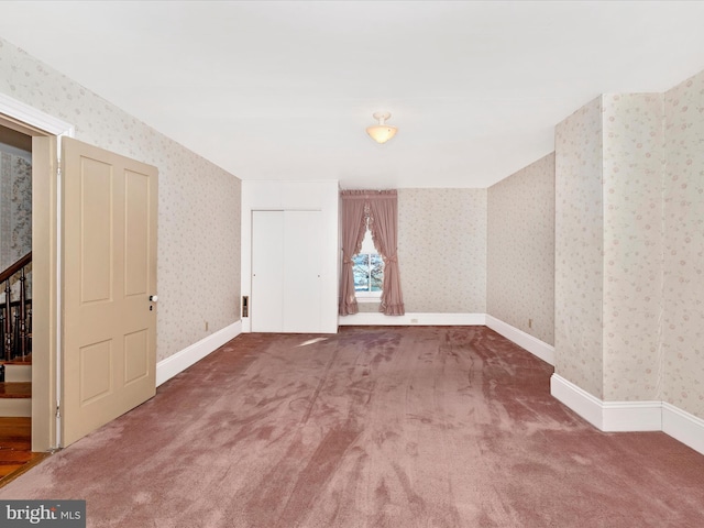 bonus room with stairs, carpet, baseboards, and wallpapered walls