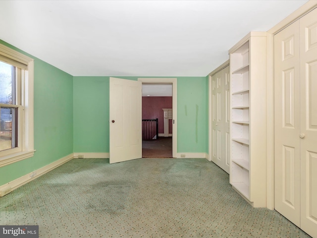 unfurnished bedroom featuring carpet flooring and baseboards