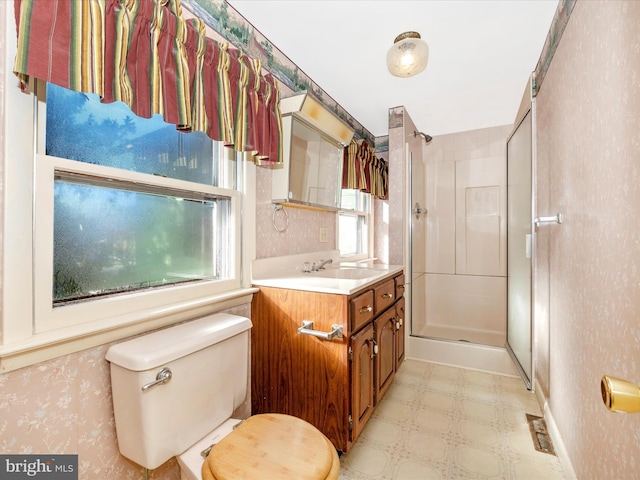 full bathroom with toilet, vanity, a shower stall, tile patterned floors, and wallpapered walls